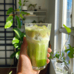 Iced coconut matcha latte served in a clear glass with visible green layers and ice cubes